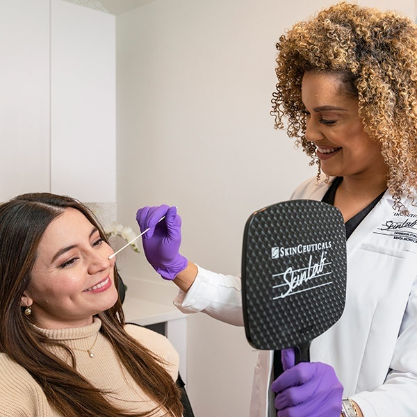 a woman getting facial treatment